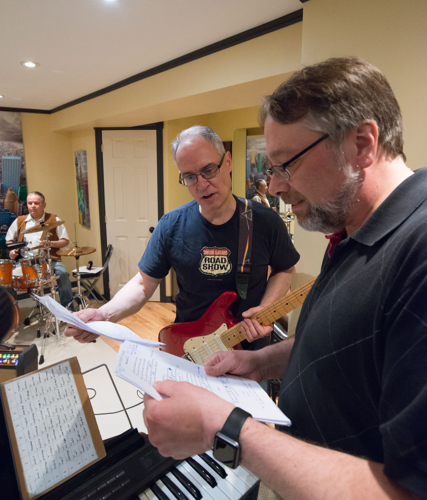 Rick Martin and Joe May look over some song notes at the Shades of Grey band practice in Kanata, Ontario, February 16, 2017. Photo by Garth Gullekson